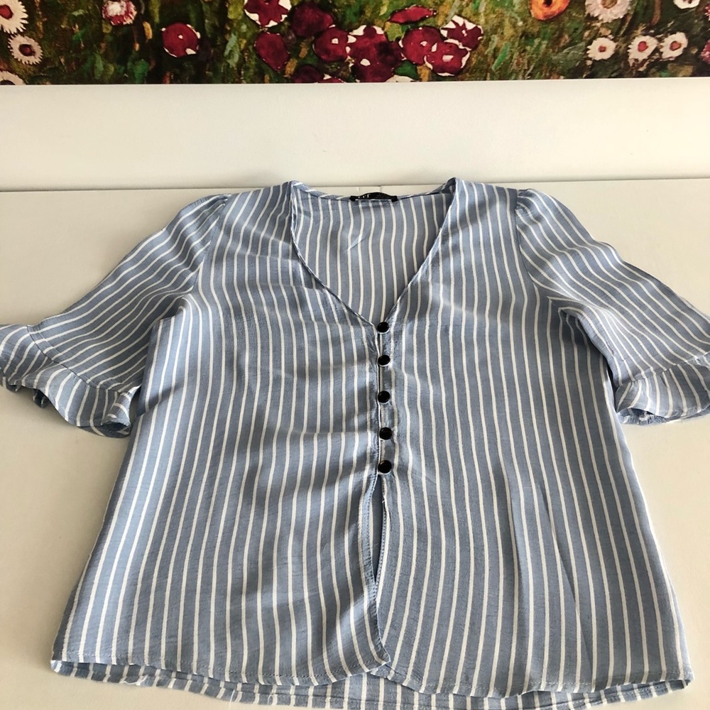 V neck shirt with stripes.